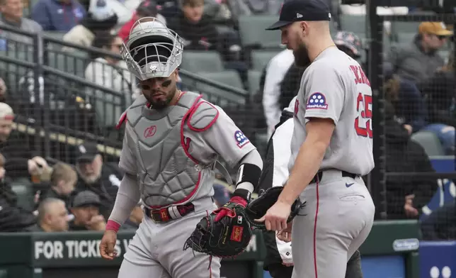 Boston Red Sox catcher Carlos Narváez, left, celebrates with starting pitcher Garrett Crochet after the fifth inning of a baseball game against the Chicago White Sox in Chicago, Sunday, April 13, 2025. (AP Photo/Nam Y. Huh)
