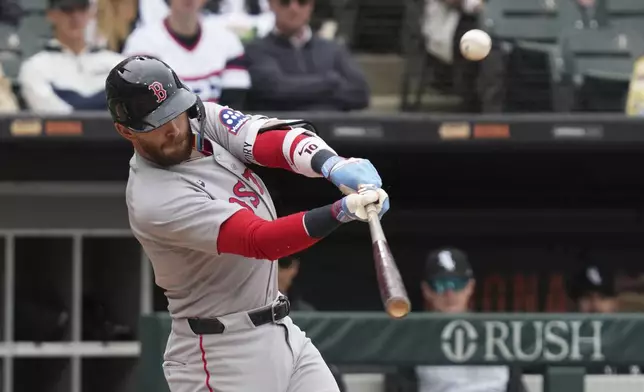 Boston Red Sox's Trevor Story hits a two-run double during the sixth inning of a baseball game against the Chicago White Sox in Chicago, Sunday, April 13, 2025. (AP Photo/Nam Y. Huh)