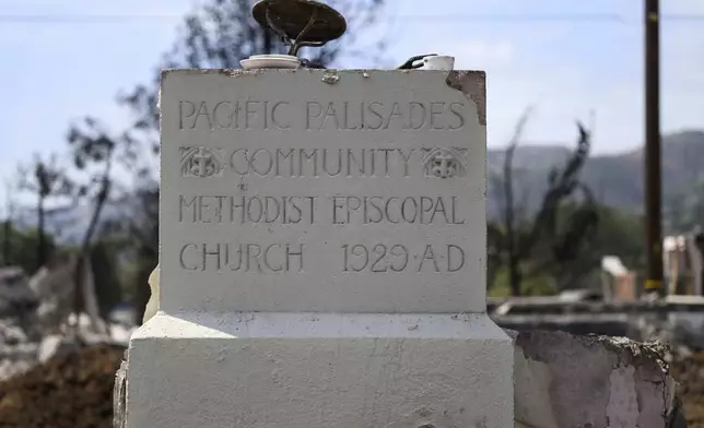 The remains of the cornerstone of the Community United Methodist Church of the Pacific Palisades are shown, Friday, April 18, 2025, in the Pacific Palisades area of Los Angeles. (AP Photo/William Liang)