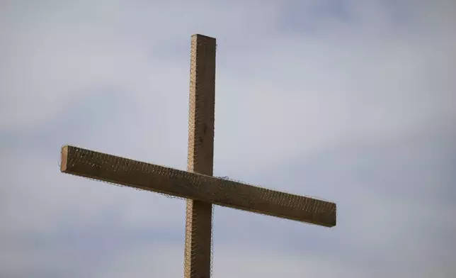 A cross is erected during a Cross Walk event by the Community United Methodist Church of the Pacific Palisades, Friday, April 18, 2025, in the Pacific Palisades area of Los Angeles. (AP Photo/William Liang)