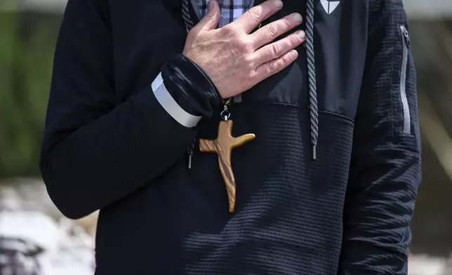 A cross necklace is seen on Pastor John Shaver during a Cross Walk event by the Community United Methodist Church of the Pacific Palisades, Friday, April 18, 2025, in the Pacific Palisades area of Los Angeles. (AP Photo/William Liang)