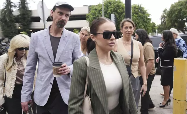 Family members and supporters of Erik and Lyle Menendez arrive in court for a hearing in their case Thursday, April 17, 2025, in Los Angeles. (AP Photo/Damian Dovarganes)