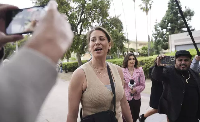 Anamaria Baralt, center, and other family members of Erik and Lyle Menendez arrive in court for a hearing in their case Thursday, April 17, 2025, in Los Angeles. (AP Photo/Damian Dovarganes)