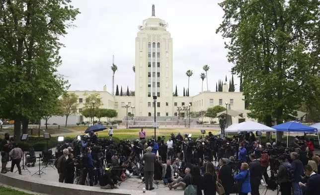 Attorney Mark Geragos, representing Erik and Lyle Menendez, bottom center, speaks to the media as he arrives for a hearing in their case, Thursday, April 17, 2025, in Los Angeles. (AP Photo/Damian Dovarganes)