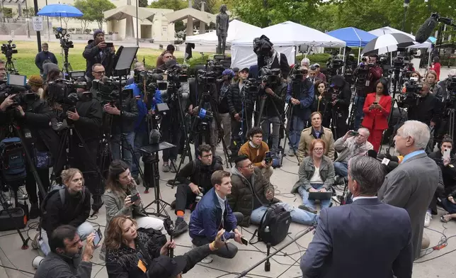 Attorney Mark Geragos, right, representing Erik and Lyle Menendez, who were sentenced in 1996 to life in prison without the possibility of parole for fatally shooting their parents, speaks to the media outside of court after a resentencing hearing in their case, Thursday, April 17, 2025, in Los Angeles. (AP Photo/Damian Dovarganes)
