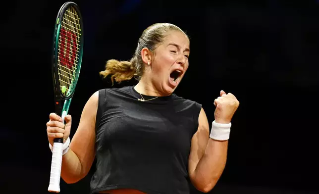 Lithuania's Jelena Ostapenko celebrates victory against against Poland's Iga Swiatek during their women's singles quarterfinal tennis match at the WTA tour in Stuttgart, Germany, Saturday, April 19, 2025. (Marijan Murat/dpa via AP)