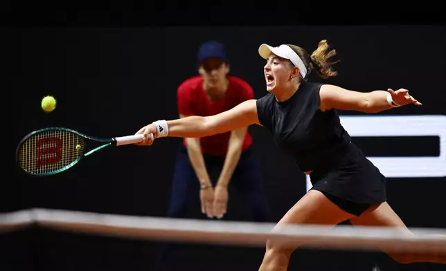 Lithuania's Jelena Ostapenko in action against Poland's Iga Swiatek during their women's singles quarterfinal tennis match at the WTA tour in Stuttgart, Germany, Saturday, April 19, 2025. (Marijan Murat/dpa via AP)