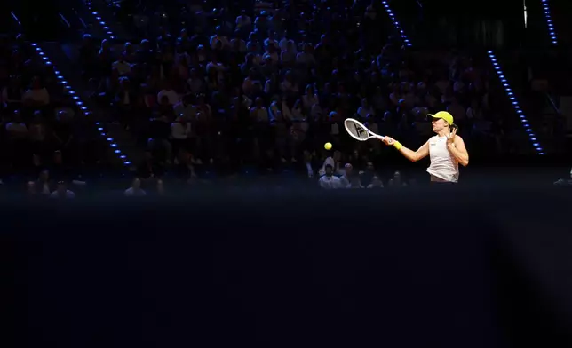 Poland's Iga Swiatek in action against Lithuania's Jelena Ostapenko during their women's singles quarterfinal tennis match at the WTA tour in Stuttgart, Germany, Saturday, April 19, 2025. (Marijan Murat/dpa via AP)
