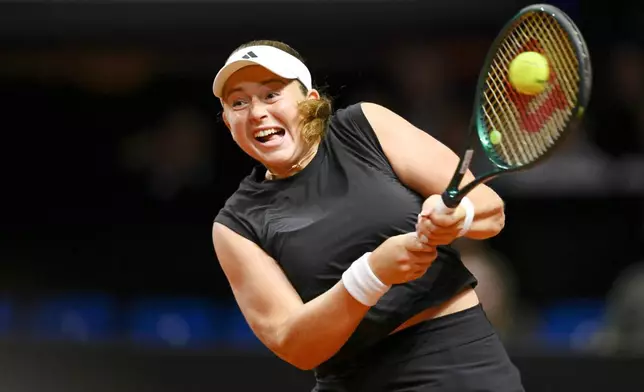 Lithuania's Jelena Ostapenko in action against Poland's Iga Swiatek during their women's singles quarterfinal tennis match at the WTA tour in Stuttgart, Germany, Saturday, April 19, 2025. (Marijan Murat/dpa via AP)