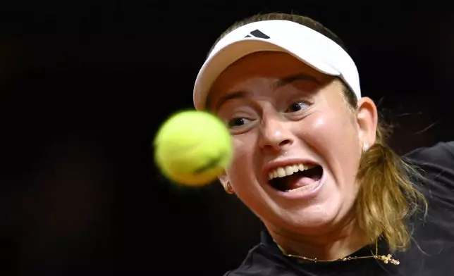 Lithuania's Jelena Ostapenko in action against Poland's Iga Swiatek during their women's singles quarterfinal tennis match at the WTA tour in Stuttgart, Germany, Saturday, April 19, 2025. (Marijan Murat/dpa via AP)