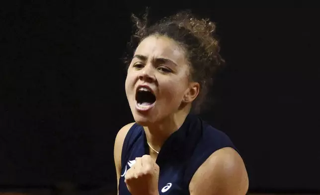 Jasmine Paolini, of Italy, reacts after her game against Coco Gauff, of the U.S., not pictured, in their women's singles quarterfinal tennis match at the WTA tour in Stuttgart, Germany, Saturday, April 19, 2025. (Marijan Murat/dpa via AP)