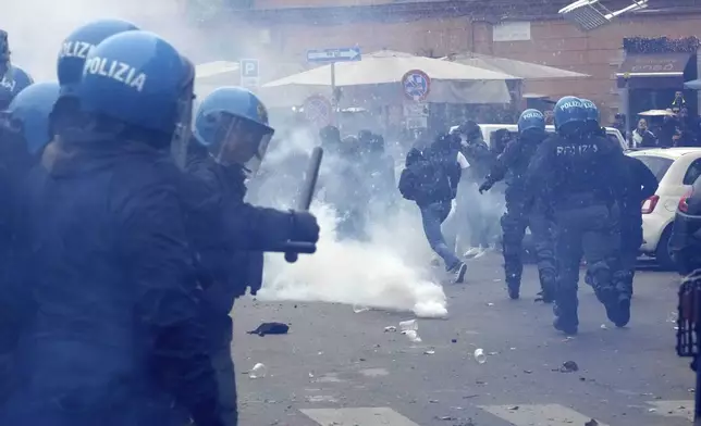 Lazio fans clash with Italian Policemen in riot gear outside the olympic stadium prior to the start of the Italian Serie A soccer match between Lazio and Roma in Rome, Sunday, April 13, 2025. (AP Photo/Gregorio Borgia)