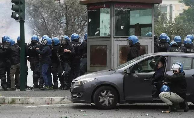 Lazio fans riot with police ahead of the Italian Serie A soccer match between Lazio and Roma at Rome's Olympic stadium, Sunday, April 13, 2025. (AP Photo/Gregorio Borgia)