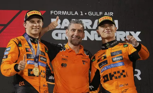 Frome the left ,first-placed McLaren driver Oscar Piastri of Australia, McLaren team principal Andrea Stella and third-placed McLaren driver Lando Norris of Britain stand on the podium after the the Formula One Bahrain Grand Prix, in Sakhir, Sunday, April 13, 2025. (AP Photo/Altaf Qadri)