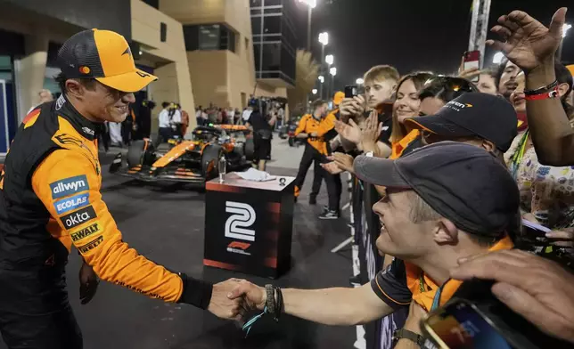 McLaren driver Lando Norris of Britain shakes hands after taking third place during the the Formula One Bahrain Grand Prix, in Sakhir, Sunday, April 13, 2025. (AP Photo/Altaf Qadri)