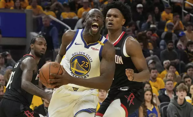 Golden State Warriors forward Draymond Green (23) drives to the basket against Houston Rockets forward Amen Thompson, right, during the first half of Game 3 of an NBA basketball first-round playoff series in San Francisco, Saturday, April 26, 2025. (AP Photo/Jeff Chiu)