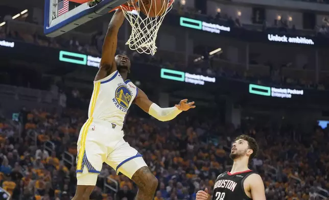 Golden State Warriors forward Jonathan Kuminga (00) dunks over Houston Rockets center Alperen Sengun (28) during the first half of Game 3 of an NBA basketball first-round playoff series in San Francisco, Saturday, April 26, 2025. (AP Photo/Jeff Chiu)