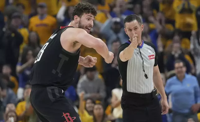 Houston Rockets center Alperen Sengun, left, reacts toward an official during the first half of Game 3 of an NBA basketball first-round playoff series against the Golden State Warriors in San Francisco, Saturday, April 26, 2025. (AP Photo/Jeff Chiu)