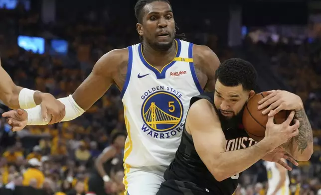 Houston Rockets guard Fred VanVleet, bottom, grabs a rebound under Golden State Warriors forward Kevon Looney during the first half of Game 3 of an NBA basketball first-round playoff series in San Francisco, Saturday, April 26, 2025. (AP Photo/Jeff Chiu)