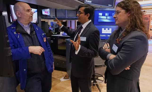 XPRIZE Carbon Removal winners from Mati Carbon, Founder &amp; CEO Shantanu Agarwal, center, and Chief Science Officer Jake Jordan, right, talk with Specialist Philip Finale during their visit to the trading floor of the New York Stock Exchange, Tuesday, April 22, 2025. (AP Photo/Richard Drew)