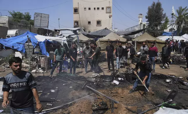 Palestinians inspect the site of an Israeli army airstrike on a tent in Gaza City, Monday, April 21, 2025. (AP Photo/Jehad Alshrafi)