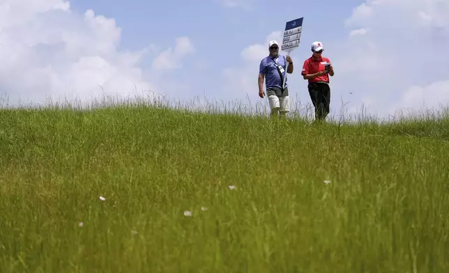 Hyo Joo Kim, of South Korea, walks on the ninth hole during the second round of the Chevron Championship LPGA golf tournament Friday, April 25, 2025, in The Woodlands, Texas. (AP Photo/Ashley Landis)