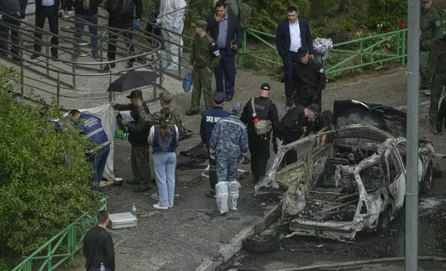 Investigators work at the scene where Lt. Gen. Yaroslav Moskalik, a deputy head of the main operational department in the General Staff of the Russian armed forces, was killed by an explosive device placed in his car in Balashikha, just outside Moscow, Russia, on Friday, April 25, 2025. (AP Photo)