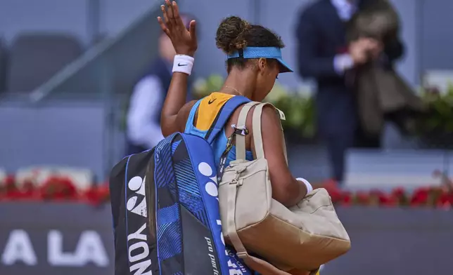 Naomi Osaka, of Japan, leaves the court after losing to Lucia Bronzetti, of Italy, at the Madrid Open tennis tournament in Madrid, Spain, Tuesday, April 22, 2025. (AP Photo/Manu Fernandez)