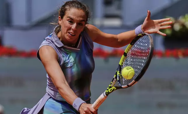 Lucia Bronzetti, of Italy, returns the ball against Naomi Osaka, of Japan, during the Madrid Open tennis tournament in Madrid, Spain, Tuesday, April 22, 2025. (AP Photo/Manu Fernandez)