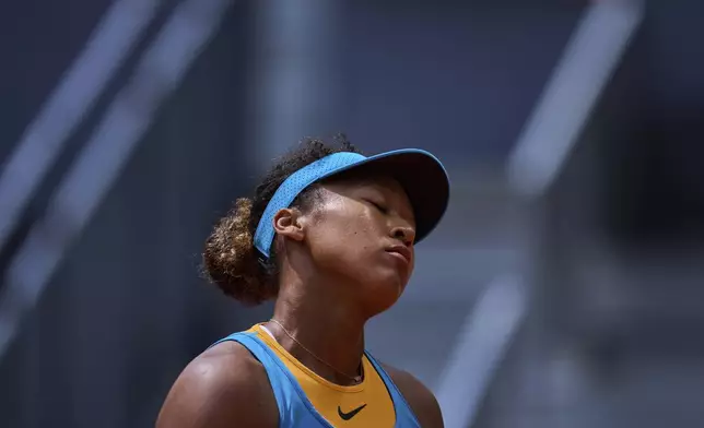 Naomi Osaka, of Japan, reacts during her match against Lucia Bronzetti, of Italy, at the Madrid Open tennis tournament in Madrid, Spain, Tuesday, April 22, 2025. (AP Photo/Manu Fernandez)