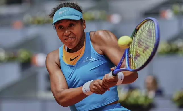 Naomi Osaka, of Japan, returns the ball against Lucia Bronzetti, of Italy, during the Madrid Open tennis tournament in Madrid, Spain, Tuesday, April 22, 2025. (AP Photo/Manu Fernandez)
