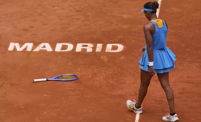 Naomi Osaka, of Japan, reacts after throwing her racket during her match against Lucia Bronzetti, of Italy, at the Madrid Open tennis tournament in Madrid, Spain, Tuesday, April 22, 2025. (AP Photo/Manu Fernandez)