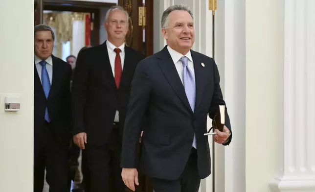 U.S. President Donald Trump's special envoy Steve Witkoff, foreground, President Vladimir Putin's investment envoy Kirill Dmitriev, second left, and Russian Presidential Aide Yuri Ushakov, left, arrive to attend the talks with Russian President Vladimir Putin at the Kremlin in Moscow, Russia, Friday, April 25, 2025. (Kristina Kormilitsyna, Sputnik, Kremlin Pool Photo via AP)