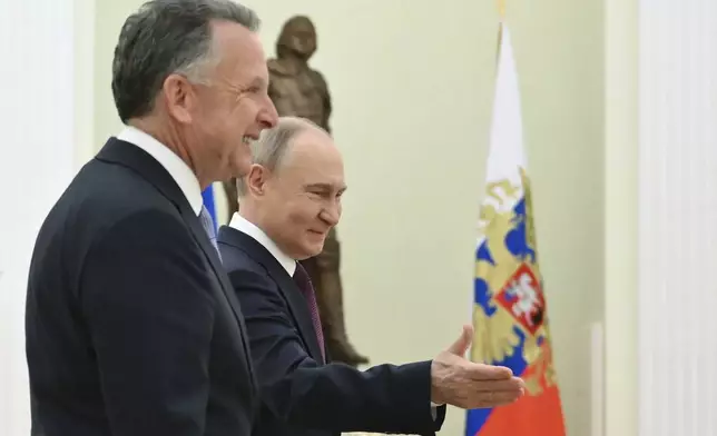 Russian President Vladimir Putin, center, welcomes U.S. President Donald Trump's special envoy Steve Witkoff to their talks at the Kremlin in Moscow, Russia, Friday, April 25, 2025. (Kristina Kormilitsyna, Sputnik, Kremlin Pool Photo via AP)
