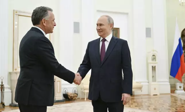 Russian President Vladimir Putin, right, and U.S. President Donald Trump's special envoy Steve Witkoff greet each other prior to their talks at the Kremlin in Moscow, Russia, Friday, April 25, 2025. (Kristina Kormilitsyna, Sputnik, Kremlin Pool Photo via AP)