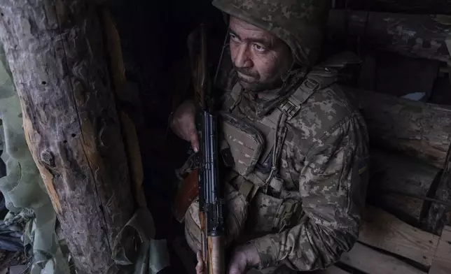 In this photo provided by Ukraine's 93rd Kholodnyi Yar Separate Mechanized Brigade press service, a soldier looks out of a shelter on the anti-drone firing position in Kostyantynivka, the site of the heavy battles with the Russian troops in the Donetsk region, Ukraine, Thursday, April 24, 2025. (Iryna Rybakova/Ukraine's 93rd Mechanized Brigade via AP).