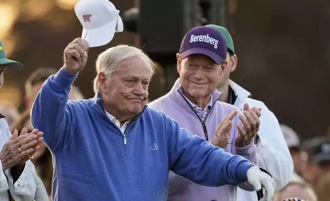 Honorary Starter Jack Nicklaus acknowledges the patrons, as fellow Honorary Starter Tom Watson applauds, on the first hole during the first round at the Masters golf tournament, Thursday, April 10, 2025, in Augusta, Ga. (AP Photo/David J. Phillip)