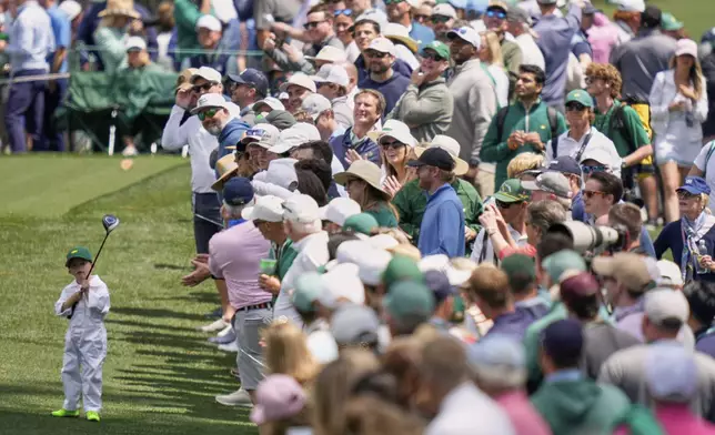 Jordan Spieth's son Sammy watches his shot on the seventh hole during the par-3 contest at the Masters golf tournament, Wednesday, April 9, 2025, in Augusta, Ga. (AP Photo/Julia Demaree Nikhinson)