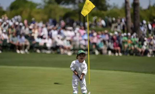 Max Homa's son, Cam Homa, laughs on green on the seventh hole during par-3 contest at the Masters golf tournament, Wednesday, April 9, 2025, in Augusta, Ga. (AP Photo/Julia Demaree Nikhinson)