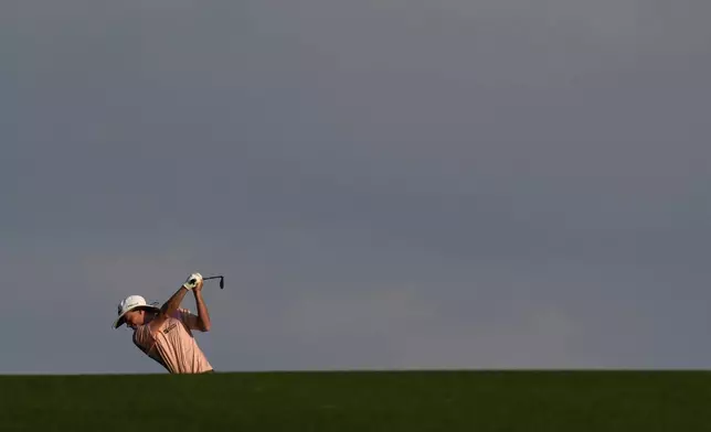 Joe Highsmith hits from the fairway on the first hole during the first round at the Masters golf tournament, Thursday, April 10, 2025, in Augusta, Ga. (AP Photo/David J. Phillip)