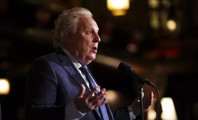 FILE - Former Quebec Premier Jean Charest speaks to reporters during a Cabinet retreat in Montebello, Quebec, Jan. 21, 2025. (Sean Kilpatrick/The Canadian Press via AP File)