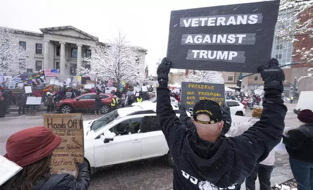 Protesters brave the wintery weather as they demontrate along North Nevada Avenue in Colorado Springs, Colo., Saturday, April 19, 2025, during a local Day of Action and Protest! demonstration outside the Colorado Springs City Hall. (Christian Murdock/The Gazette via AP)