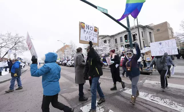Demonstrators march in downtown Colorado Springs, Colo., Saturday, April 19, 2025, during a local Day of Action and Protest! demonstration outside the Colorado Springs City Hall. (Christian Murdock/The Gazette via AP)