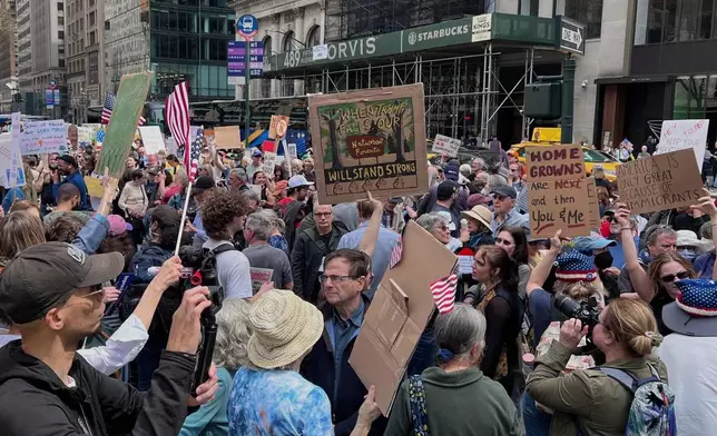 People gather to protest President Donald Trump's policies on Saturday, April 19, 2025 in New York. (AP Photo/Joseph Frederick)