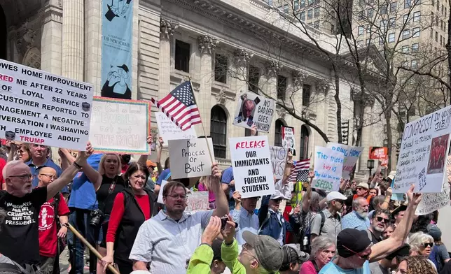 People gather to protest President Donald Trump's policies on Saturday, April 19, 2025 in New York. (AP Photo/Joseph Frederick)