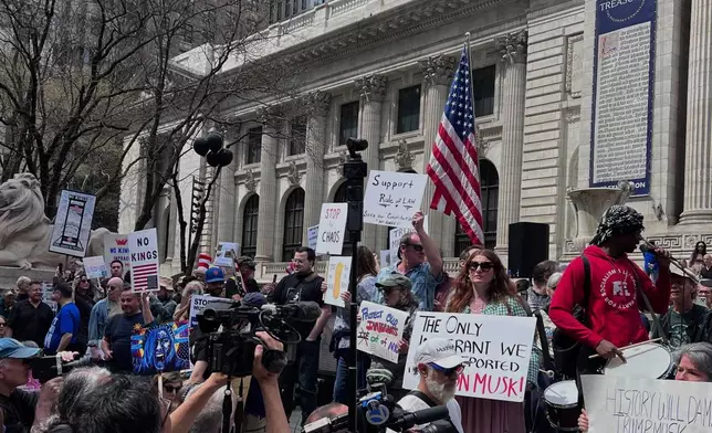 People gather to protest President Donald Trump's policies on Saturday, April 19, 2025 in New York. (AP Photo/Joseph Frederick)