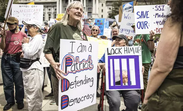 Protesters rally at the state capitol in Harrisburg, Pa., during the Day of Action protest against the Trump Administration. Saturday, April 19, 2025. (Zach Gleiter/The Patriot-News via AP)