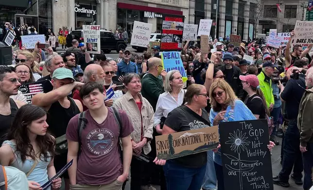 People gather to protest President Donald Trump's policies on Saturday, April 19, 2025 in New York. (AP Photo/Joseph Frederick)