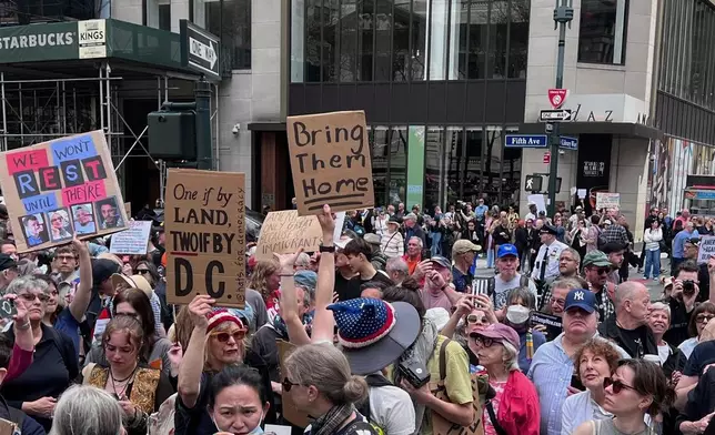 People gather to protest President Donald Trump's policies on Saturday, April 19, 2025 in New York. (AP Photo/Joseph Frederick)