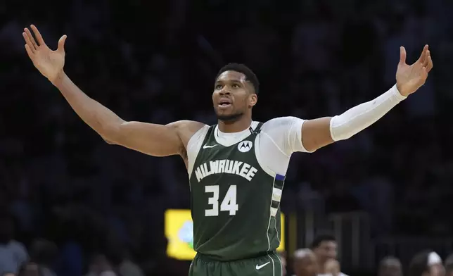 Milwaukee Bucks forward Giannis Antetokounmpo (34) reacts after Kevin Porter Jr. scored during overtime in an NBA basketball game against the Miami Heat, Saturday, April 5, 2025, in Miami. (AP Photo/Lynne Sladky)